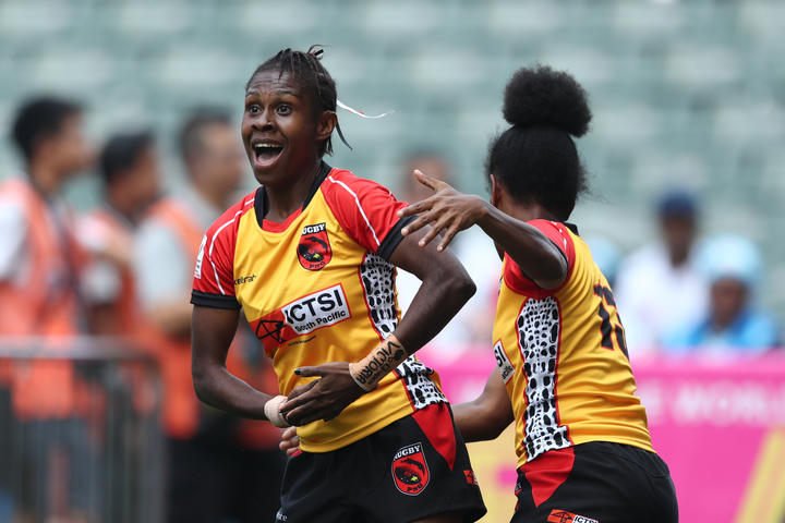 Papua New Guinea's Alice Alois celebrates a try against Scotland during the Women's World Sevens Series Qualifier in Hong Kong