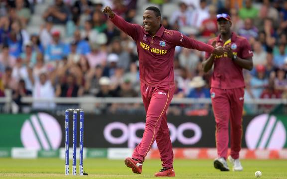 West Indies' Sheldon Cottrell celebrates after the dismissal of New Zealand's Tom Latham during the 2019 Cricket World Cup group stage match between West Indies and New Zealand at Old Trafford in Manchester