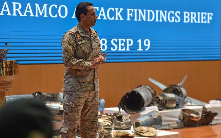 Saudi defence ministry spokesman Colonel Turki bin Saleh al Malki shows pieces of what he said were Iranian cruise missiles and drones recovered from the attack site that targeted Saudi Aramco's facilities 18 September 2019