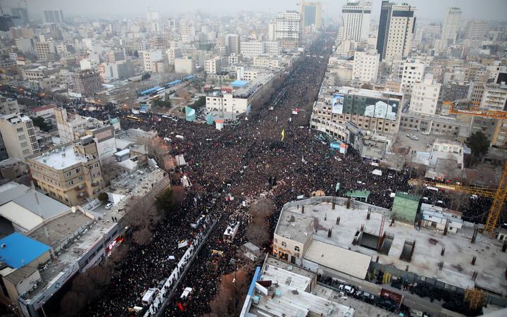 Iranians march behind a vehicle carrying the coffins of slain major general Qassem Soleimani and others as they pay homage in the northeastern city of Mashhad