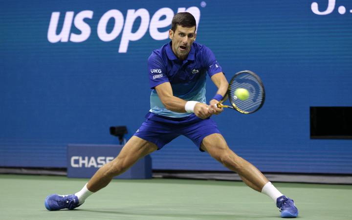 Serbia's Novak Djokovic hits a return to Germany's Alexander Zverev during their 2021 US Open Tennis tournament men's semifinal match at the USTA Billie Jean King National Tennis Center in New York, on September 10, 2021. 