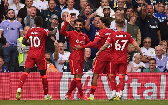 Liverpool's Egyptian midfielder Mohamed Salah (2nd L) celebrates scoring the opening goal during the English Premier League football match between Leeds United and Liverpool at Elland Road in Leeds, northern England on September 12, 2021. 