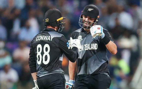 Daryl Mitchell (R) of the New Zealand BlackCaps celebrates with team mate Devon Conway after hitting a boundary during the ICC Men's T20 World Cup semifinal between New Zealand and England at Sheikh Zayed Cricket Stadium, Abu Dhabi, UAE on Wednesday 10th November 2021. 