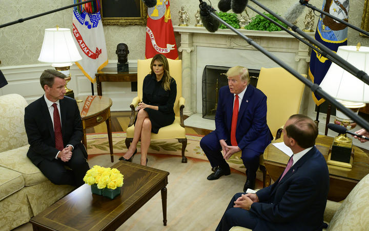 Donald Trump flanked by acting Commissioner of Food and Drug Norman Sharpless left Melania Trump and US Secretary of Health and Human Services Alex Azar