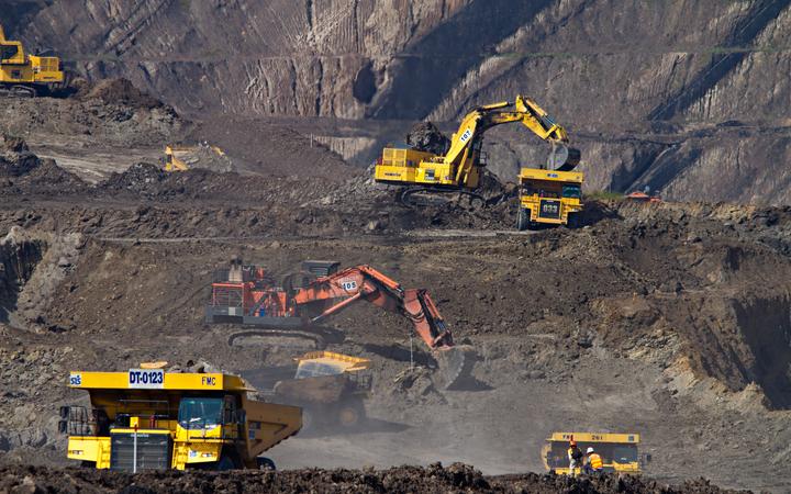Excavators and trucks at a coal mine in South Kalimantan Indonesia