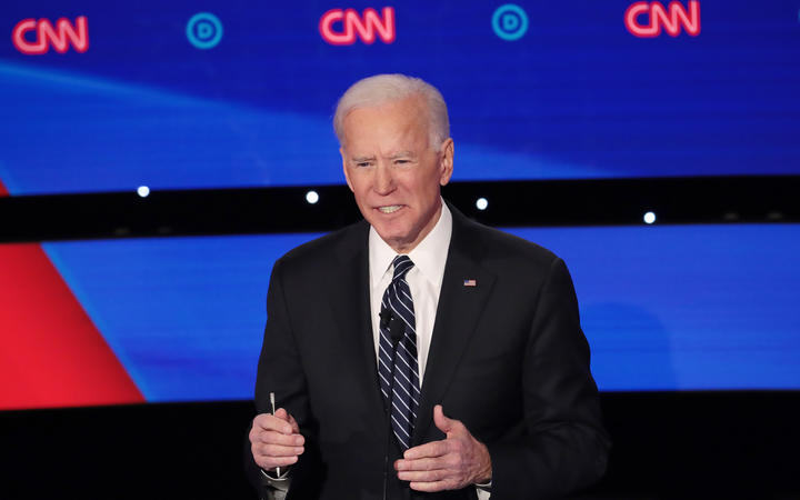 Former Vice President Joe Biden delivers his closing statement during the Democratic presidential primary debate at Drake University