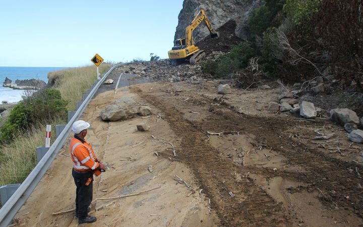 Workers clear the slip at Ohau Point north of Kaikōura.