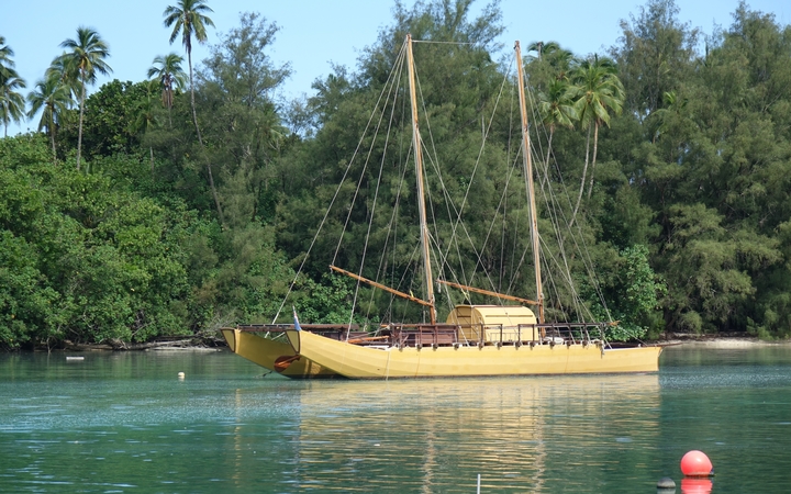 Traditional vessel at anchor in the channel leading to Rarotonga's Muri lagoon, Cook Islands