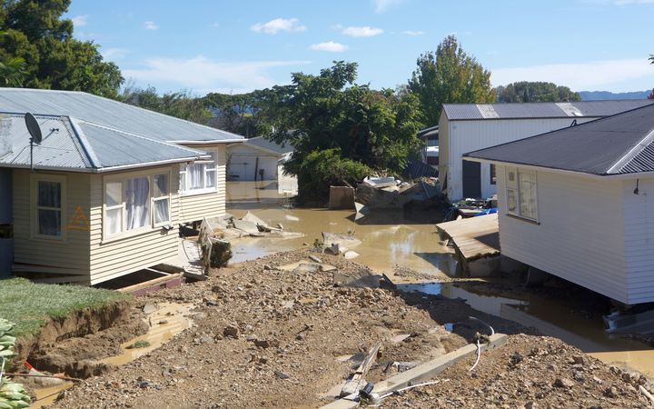 Severely damaged houses in Edgecumbe, after floodwaters tore through the town.