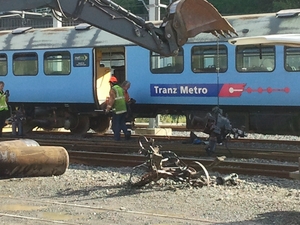 Mangled pieces of the train are removed at the Wellington station.