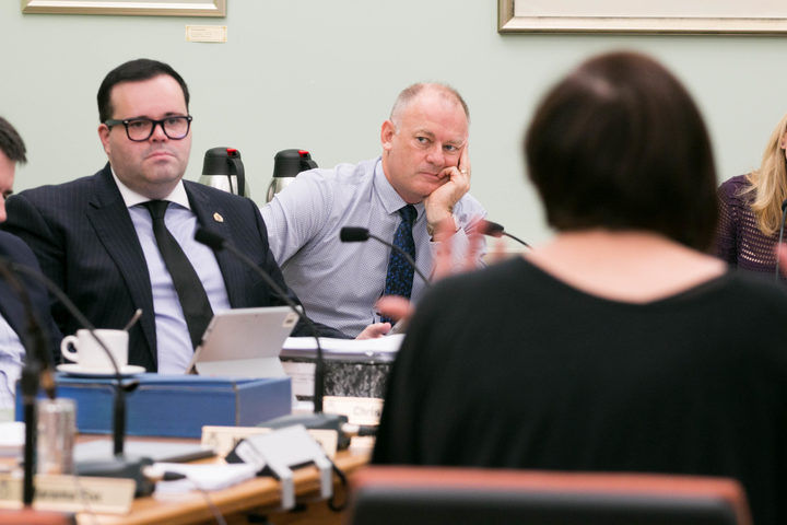 National MPs Paul Foster-Bell (left) and Jono Naylor (right) listen to Jan Logie (foreground) speak to the Justice and Electoral committee on her Domestic Violence-Victim's Protection Bill. 