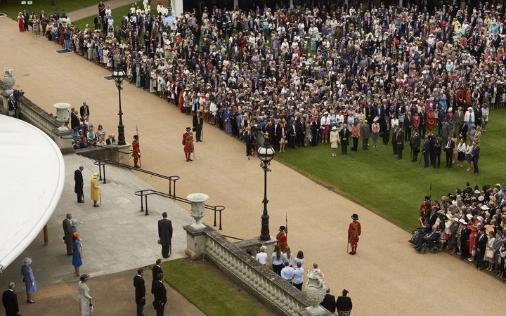 Britain's Queen Elizabeth II and Prince Philip observe a minute's silence at the start of a Special Garden Party at Buckingham Palace in London following the attack at Manchester Arena.