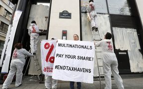 Activists from the Association for the Taxation of financial Transactions and Citizen's Action (ATTAC) demonstrate in Paris against tax avoidance.