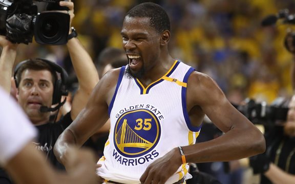 Golden State Warrior Kevin Durant celebrates winning his first NBA championship title.