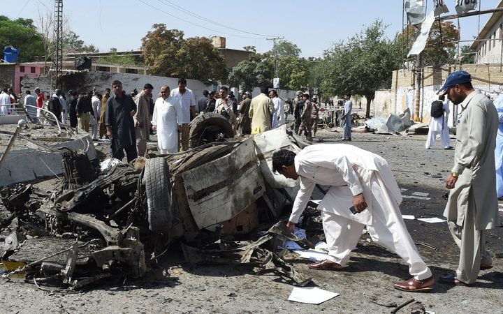 Pakistani security officials inspect the site of a powerful explosion that targeted a police vehicle in Quetta on June 23, 2017