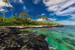 Beach with coral reef and black volcanic rocks on south side of Upolu, Samoa Islands