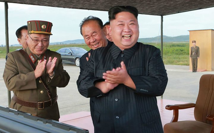North Korean leader Kim Jong-Un (C) inspecting a launching drill of the medium-and-long range strategic ballistic rocket Hwasong-12.