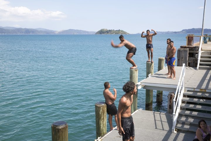 A group of teenagers and kids cooling off at Petone Wharf on 15 January.