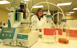 A lab technician working at a milk processing plant.