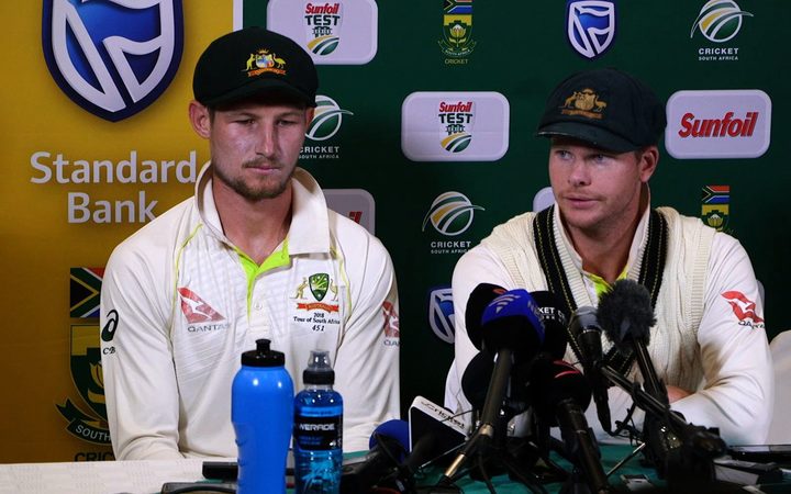 Australia's captain Steve Smith (R), flanked by teammate Cameron Bancroft, speaking as he admitted to ball-tampering during the third Test against South Africa.