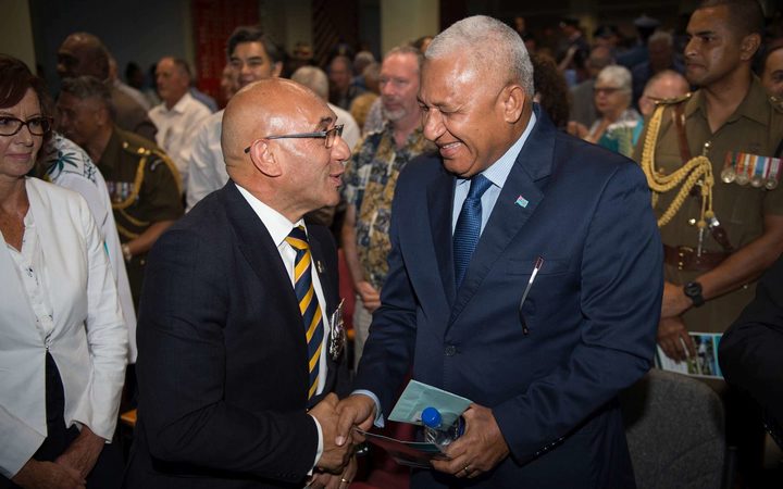 At a ceremony in a cramped lecture theatre at Laucala Bay, NZ's defence minister Ron Mark and Prime Minister Frank Bainimarama of Fiji shook hands. 