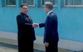 Korean leaders Kim Jong-un and Moon Jae-in meet at the Korean border.
