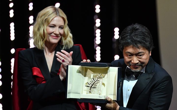 Japanese director Hirokazu Kore-Eda (R) poses on stage with Australian actress and President of the Jury Cate Blanchet