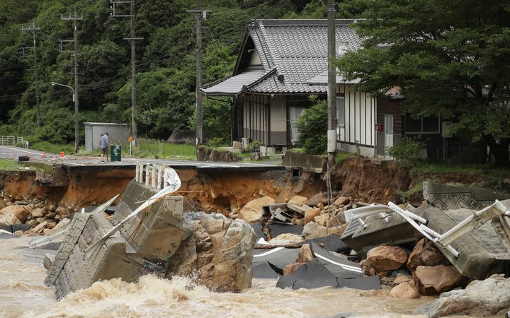 This picture shows a collapsed road due to heavy rain in Higashihiroshima, Hiroshima prefecture on July 7, 2018.