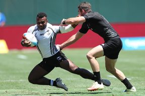 Fiji captain Jerry Tuwai is caught by the New Zealand defence.