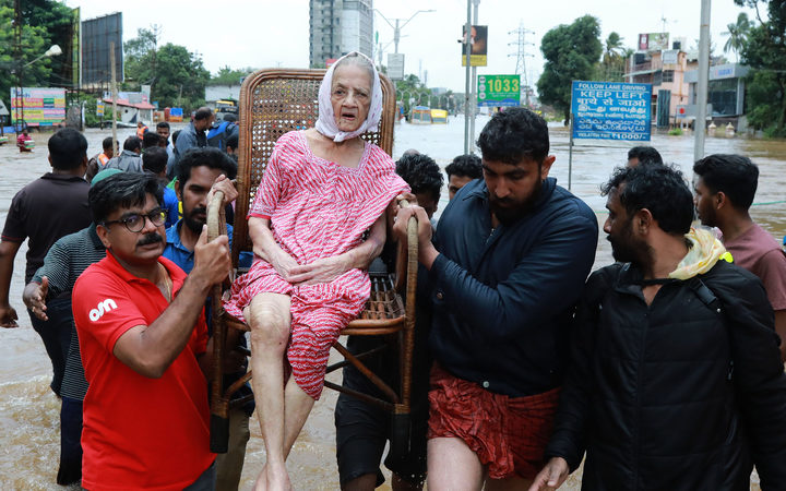 Indian volunteers and rescue personnel evacuate local residents
