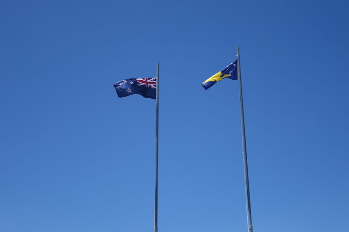 Tokelau and New Zealand flags flying in Atafu, Tokelau