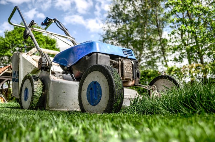 A lawnmower cutting grass