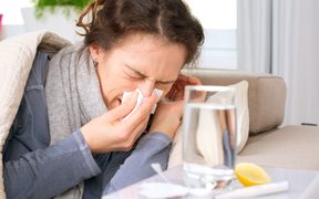 sick woman flu, cold sneezing into tissue
