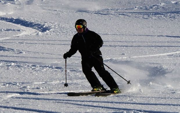 Skiers get in their first turns for the 2014 snow season at Mt Hutt.