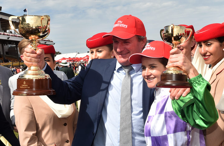 Jockey Michelle Payne (right) and trainer Darren Weir (left) of Australia hold up their Melbourne Cups after winning the race on Prince of Penzance at Flemington Racecourse in Melbourne in 2015.