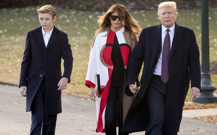 President Donald Trump accompanied by first lady Melania Trump, and their son Barron