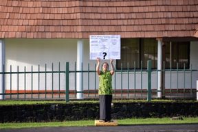 Moira Maiava holding her one woman protest for better health care in American Samoa