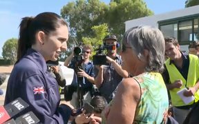 Prime Minsiter Jacinda Ardern speaks to evacuees ahead of the press conference. 
