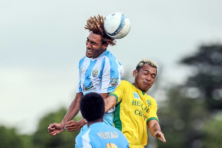 Hienghene Sport's Cedrick Sansot wins the header from AS Tefana's Tehauarii Holozet. 
