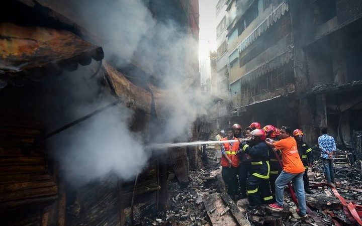 Firefighters try to extinguish a fire in Dhaka on February 21, 2019.