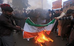 Pakistani protesters burn an Indian national flag during a protest in Peshawar on February 26, 2019, following the Indian Air Force strike launched on a Jaish-e-Mohammad camp at Balakot.
