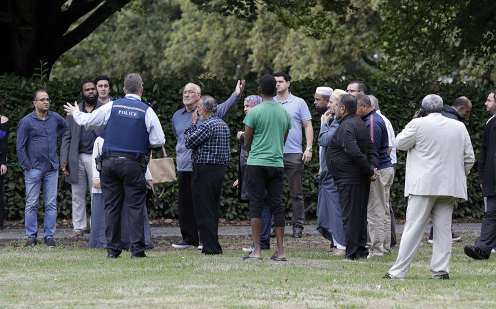 Police talk to witnesses near a mosque in central Christchurch, New Zealand, Friday, March 15, 2019. 