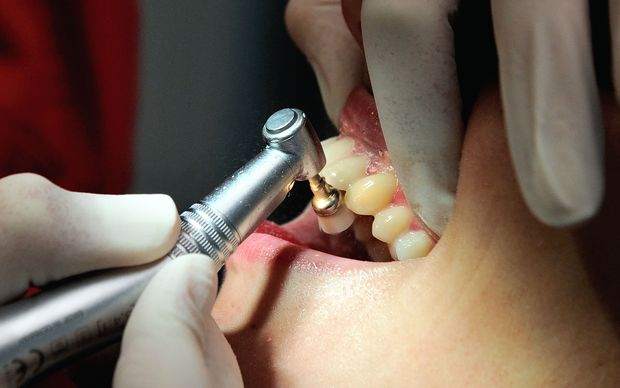 Dentist treating patient.
