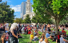 Crowds gather at an Auckland vigil for those affected by Friday's terror attack