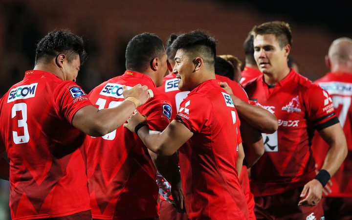 The Sunwolves celebrate their upset win over the Chiefs in Hamilton.