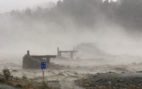 The Waiho Bridge has been totally taken out by the raging floodwaters.