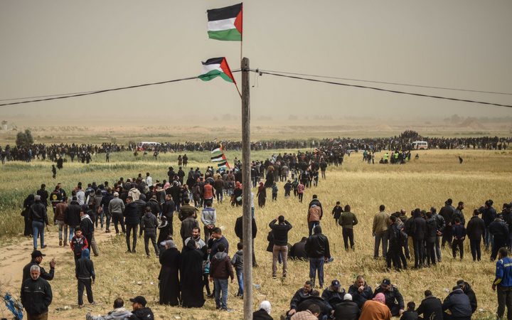 Palestinians attend a protest within the "Great March of Return" and "Palestinian Land Day" demonstrations at Israel-Gaza border in Khan Yunis