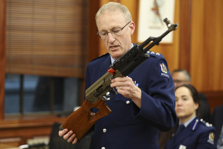 Acting Superintendant Michael McIlraith demonstrates how semi-automatic weapons can be illegally modified