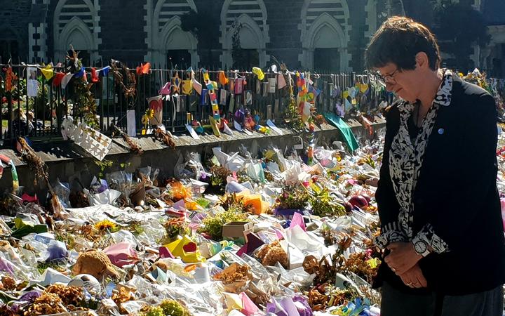 UN deputy high commissioner for human rights Kate Gilmore at the wall of flower tributes offered to victims of the Christchurch terror attacks. 