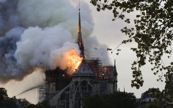 Flames and smoke billow from the roof of Notre-Dame Cathedral in Paris.